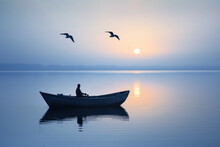 Person In Small Wooden Boat On Calm Sea At Sunrise