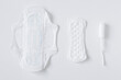 Set of different sanitary pads and tampon on white