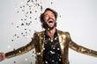 © igolaizola - excited man in golden jacket throwing confetti isolated on a white background