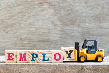 Canvas Print - Toy forklift hold letter block y to complete word employ on wood background