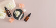 natural skin care for the face and body. Two bottles of cosmetics and a roller massager on a dark marble podium. Top view. banner. A copy space.