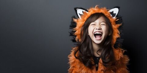 Wall Mural - Cute Young Asian Girl Dressed as a Kitty Cat for Halloween with Space for Copy