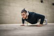 © Miljan Živković - One man young adult caucasian male training outdoor doing push ups