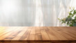 © kanurism - Empty wooden table for product presentation with blurred window blinds background