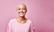 © ink drop - Studio portrait of a happy cancer patient against a pink background