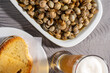 © Jmanita - Delicious Portuguese delicacy: Snails served with crispy toast and accompanied by a refreshing cold beer. A quintessential snack from Portugal.