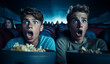 © annebel146 - Young scared teenagers couple at the cinema watching an horror movie and screaming in the Cinema, looking scared. eating popcorn. Friday Night
