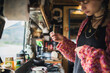 © Marco Reggi/Stocksy - Young woman preparing a tea.
