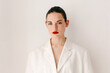 © Tania Cervian/Stocksy - Stylish woman with red lips near wall