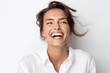 © igolaizola - Close up portrait of a happy young woman laughing on a white background