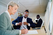 © Bruce and Rebecca Meissner/Stocksy - Colleagues working together in an office space