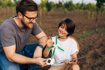 Wall Mural - Father loves to spend time with his son and teach him about renewable emery.