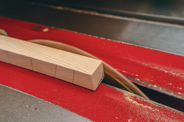 Sticker - The process of cutting a wooden board on a circular machine. View from above. Wood dust.