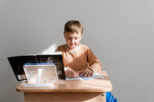 Student At Desk In Light Classroom