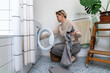 © Basil Pind/Stocksy - woman woking with washing machine