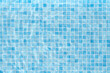 © Yaroslav Danylchenko/Stocksy - Swimming pool with water and blue tiles background.