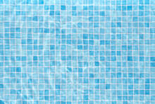 Swimming Pool With Water And Blue Tiles Background.