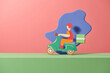 © Marc Tran/Stocksy - Food delivery man riding a red scooter craft and paper art style