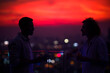 © Jovo Jovanovic/Stocksy - Friends talking during sunset drinks on rooftop