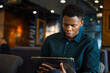 © Jovo Jovanovic/Stocksy - Black entrepreneur working on tablet in cafe