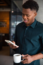 Black Entrepreneur Receiving Message While Getting Coffee