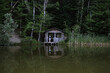 © Alina Miluseva/Stocksy - Woman standing Near Abandoned Wooden Cabin In Forest