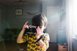 © Maria Manco/Stocksy - Boy takes photo