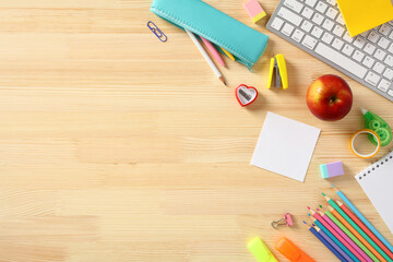 Wall Mural - Back to school concept. Colorful school supplies on wooden desk table. Flat lay, top view.