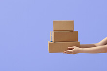 Hands Holding Boxes Stacked On Color Isolated Background