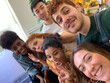 © Luis Velasco/Stocksy - UGC Selfie, Multiracial Group Of Friends Together In the Kitchen.