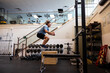 © Rob and Julia Campbell/Stocksy - Dymanix box jump exercise at the gym.