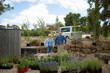 © Rowena Naylor/Stocksy - Landscape Architect and client with purchase plants for new garden