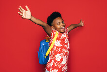 Cheerful Black Kid With Backpack And Arms Wide Open