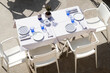 © Sonja Lekovic/Stocksy - white dining table and chairs outdoor