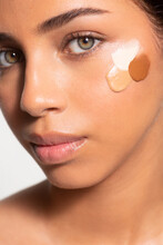 Woman With Cosmetic Foundation Swab On Face