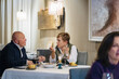 © Daniel Gonzalez/Stocksy - Couple talking over dinner at table in restaurant