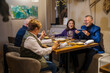 © Daniel Gonzalez/Stocksy - Group of friends having dinner in restaurant