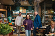 © Daniel Gonzalez/Stocksy - Smiling middle aged couple looking at food counter