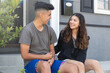 © Jordana Sheara/Stocksy - Teen couple being sweet together outside a suburban home