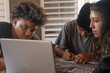 © Jordana Sheara/Stocksy - Teenagers studying together with a laptop at home