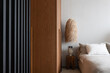 © Luciano Spinelli/Stocksy - Wood furniture with vertical lines in bedroom with natural materials