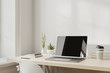 © Oleksandr Shcherban/Stocksy - Laptop with books and notebooks on wooden desk, workplace, 3d render