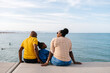 © Ezequiel Giménez/Stocksy - Happy family spending weekend on embankment