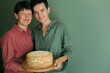 © Duet Postscriptum/Stocksy - Adult mother and adult daughter pose with homemade cake
