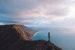 © Berena Alvarez/Stocksy - girl in viewpoint in front of the ocean