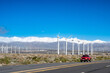© Rowena Naylor/Stocksy - Highway with Wind farm