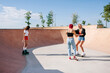 © Nibuya Qubik/Stocksy - Young blonde latin Teen girl learning to skate with her friends