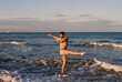 © Berena Alvarez/Stocksy - Male ballet dancer posing on the beach at sunset