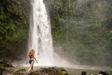 Woman In Swimwear Walking At Waterfall In Bali