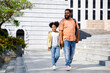 © Jovo Jovanovic/Stocksy - Girl student walking with her father on school building staircase